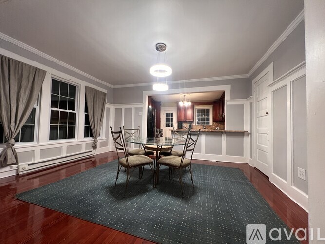 A dining room with a table set for four.