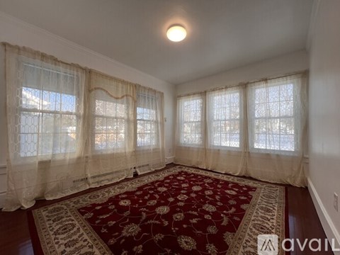 A dining room with a table set for four.