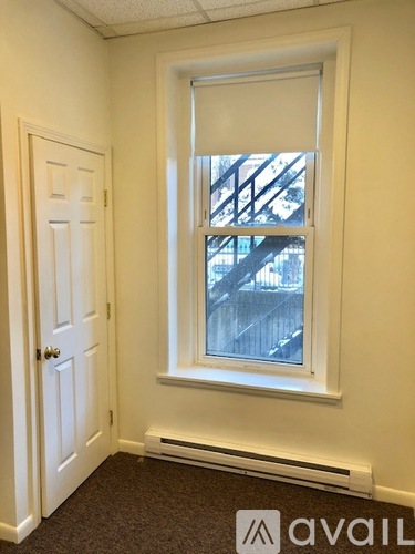 A room with a window and a door.