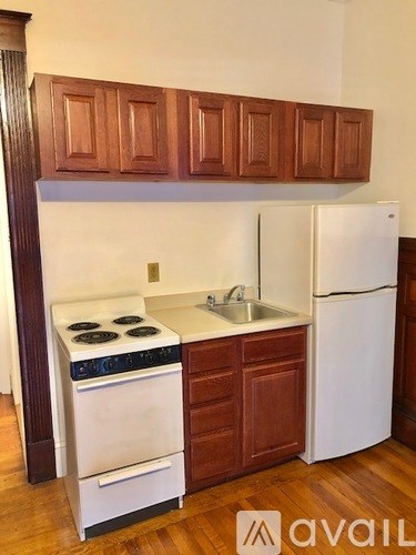 A kitchen with wooden cabinets and white appliances.