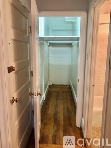 A hallway with a door on the left and a glass door on the right.
