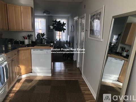 A kitchen with wooden cabinets and a white dishwasher.