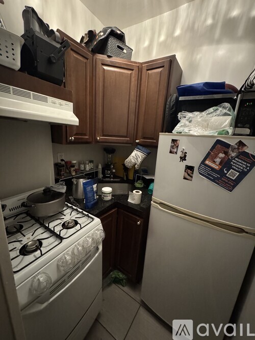 A small kitchen with a white stove and a white refrigerator.