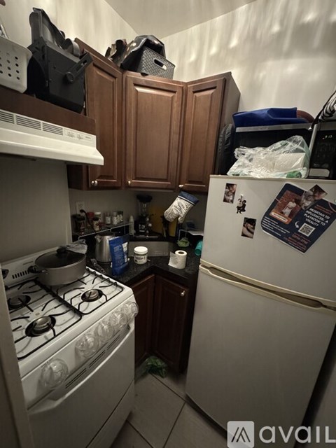A small kitchen with a white stove and a white refrigerator.