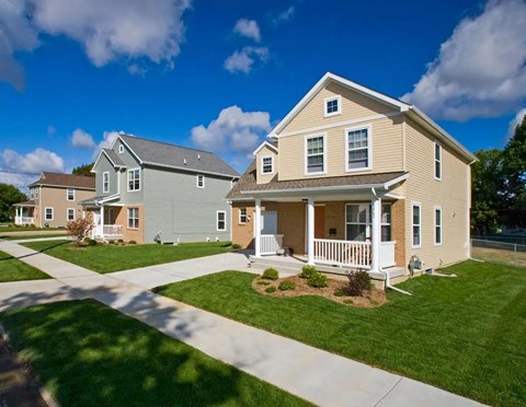 A house with a well-maintained lawn and a clear sky.
