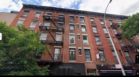A red brick building with a black fire escape.