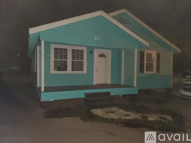 A small blue house with a white door and windows is shown.
