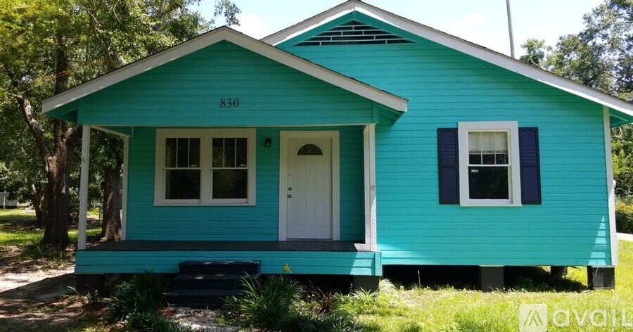A blue house with the number 830 on the front.