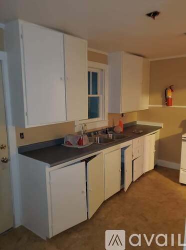 A kitchen with white cabinets and a countertop.