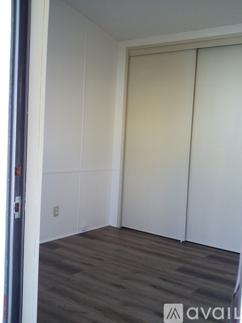 A room with a sliding door and a grey floor.