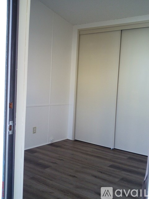 A room with a sliding door and a grey floor.