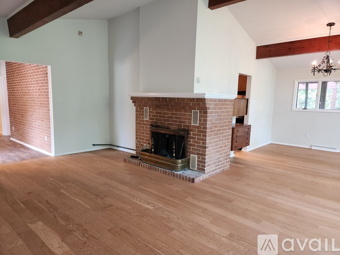 A room with a fireplace and wooden floors.