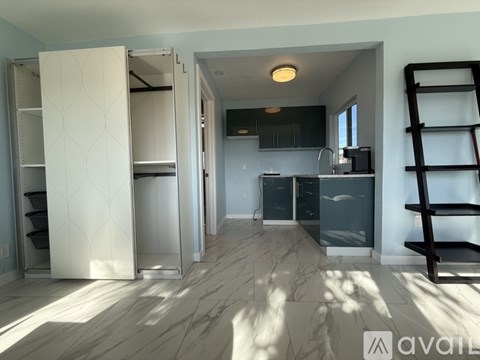 A kitchen with a white refrigerator and a wooden ladder.