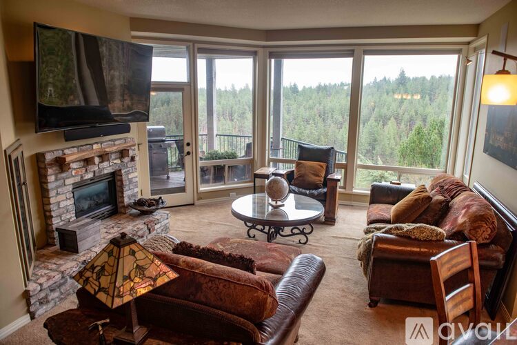 A living room with a fireplace and a flat screen TV.