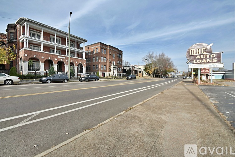 A street view with a building on the left and a sign for Mac Auto Loans on the right.