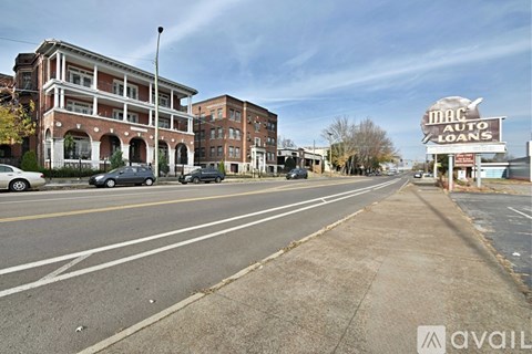 A street view with a building on the left and a sign for Mac Auto Loans on the right.