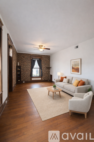 A living room with a couch, chair, and rug.