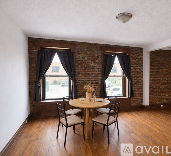 A dining room with a wooden table and chairs.