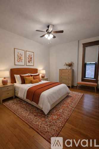 A bedroom with a bed, dresser, and window.