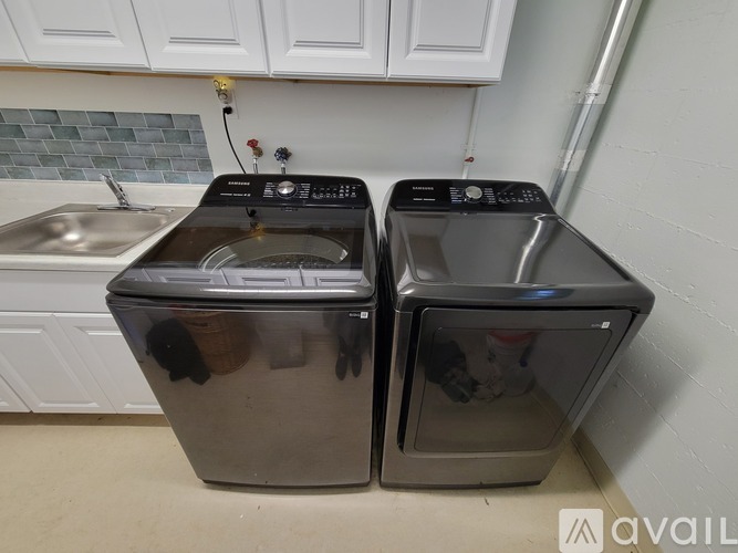 Two front loading washing machines in a kitchen.