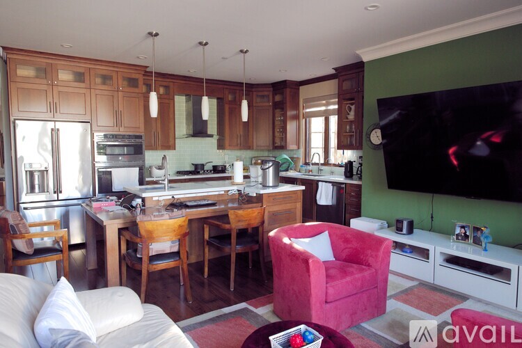A kitchen with a red chair and a white couch.