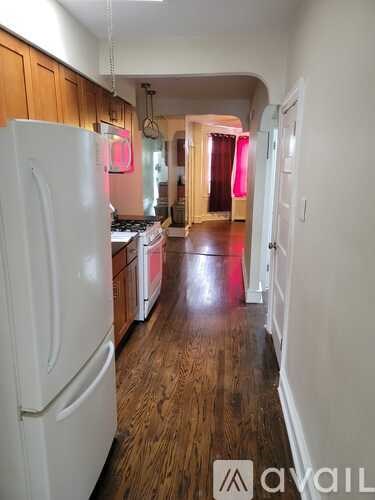 A white refrigerator is in the kitchen.