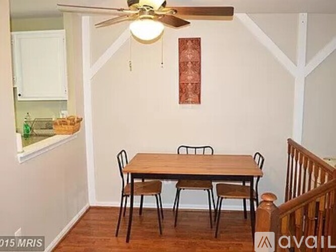 A dining room with a table and chairs.