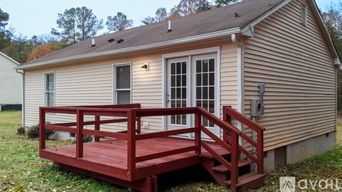 A house with a red deck in front.