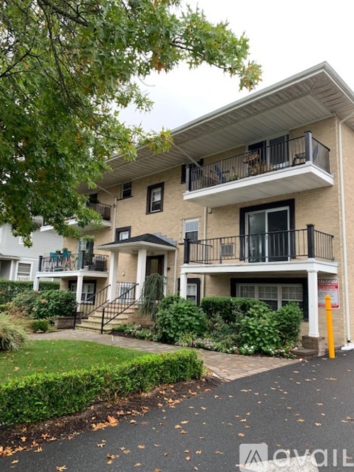 A two-story apartment building with a balcony on the second floor.