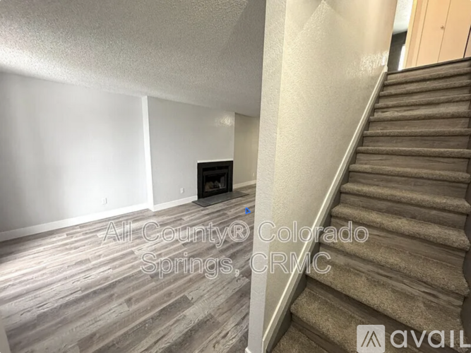 A staircase with a carpeted runner and wooden steps.