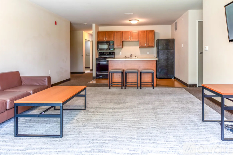 A living room with a couch, a table, and a television.