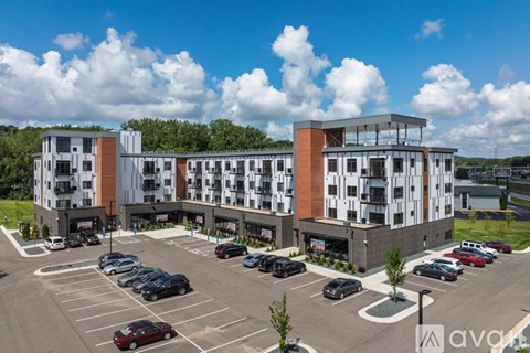A parking lot in front of a multi-story building.