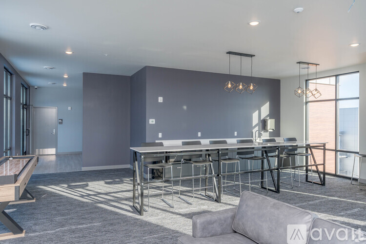A modern dining area with a long table and chairs.