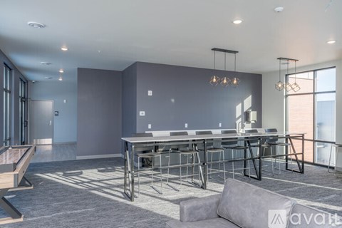 A modern dining area with a long table and chairs.