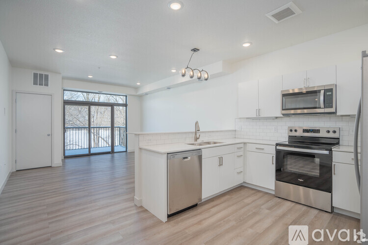 A kitchen with white cabinets and stainless steel appliances.