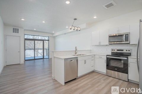 A kitchen with white cabinets and stainless steel appliances.