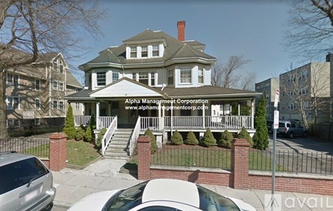 A house with a sign that says Alpha Management Corporation.