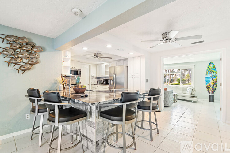 A dining room with a table and chairs.