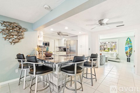 A dining room with a table and chairs.