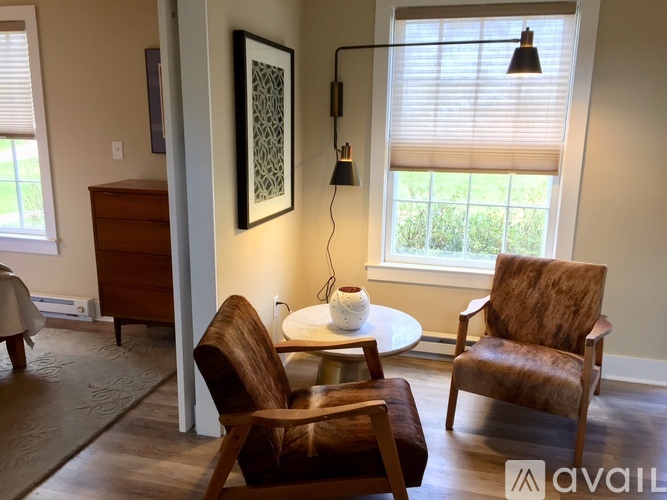 A living room with a brown chair and a white table.