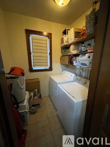 A small, cluttered laundry room with a washer and dryer.