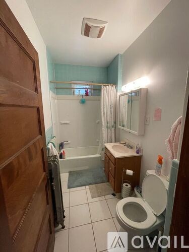 A bathroom with a toilet, sink, and shower.