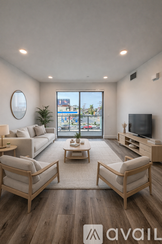 A living room with a couch, chairs, and a television.