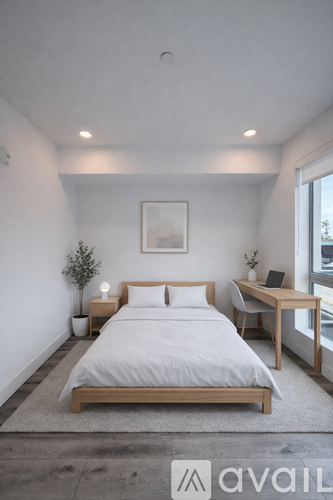 A bedroom with a bed, desk, and chair.