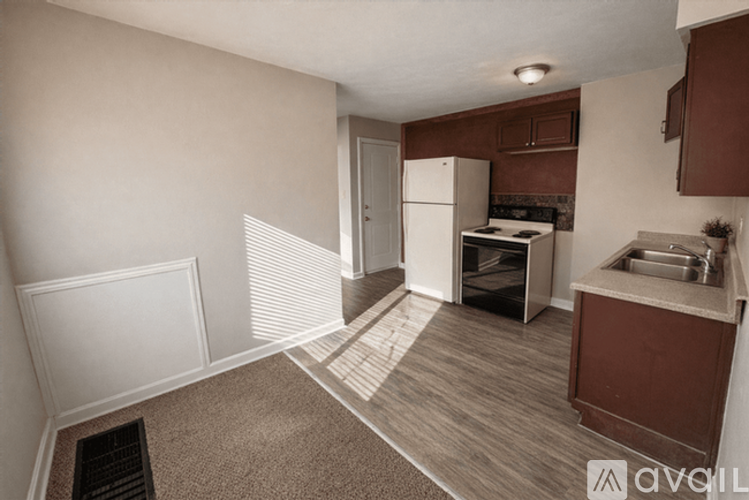 A kitchen with a refrigerator, stove, and sink.