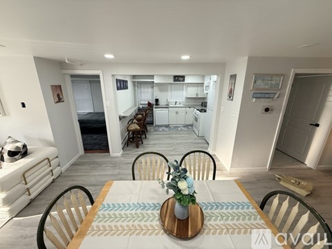 A dining room with a table set for four.