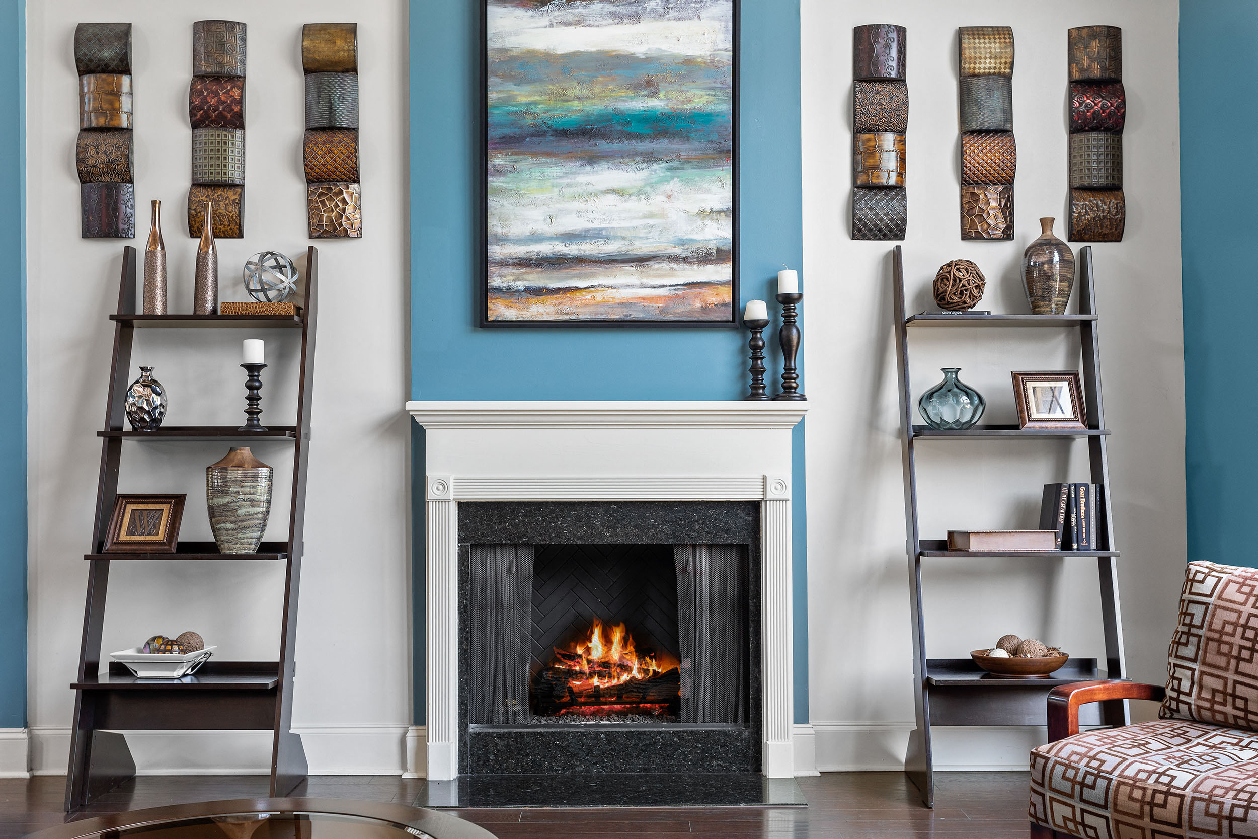 Small fireplace with a bookshelf on each side at Walnut Hill Apartment Homes resident clubhouse