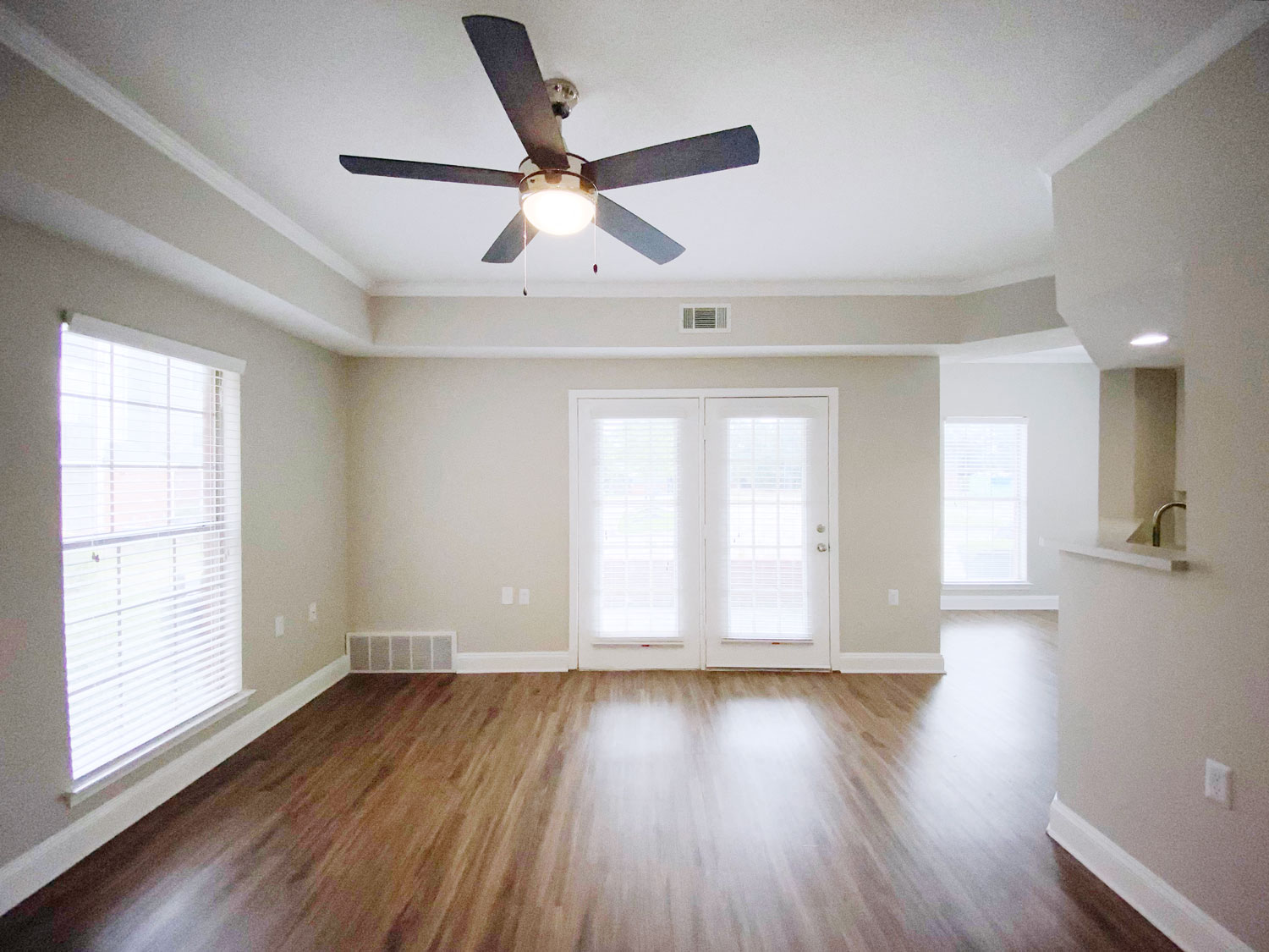 Spacious renovated living area in Cordova apartment for rent with new flooring doors out to patio