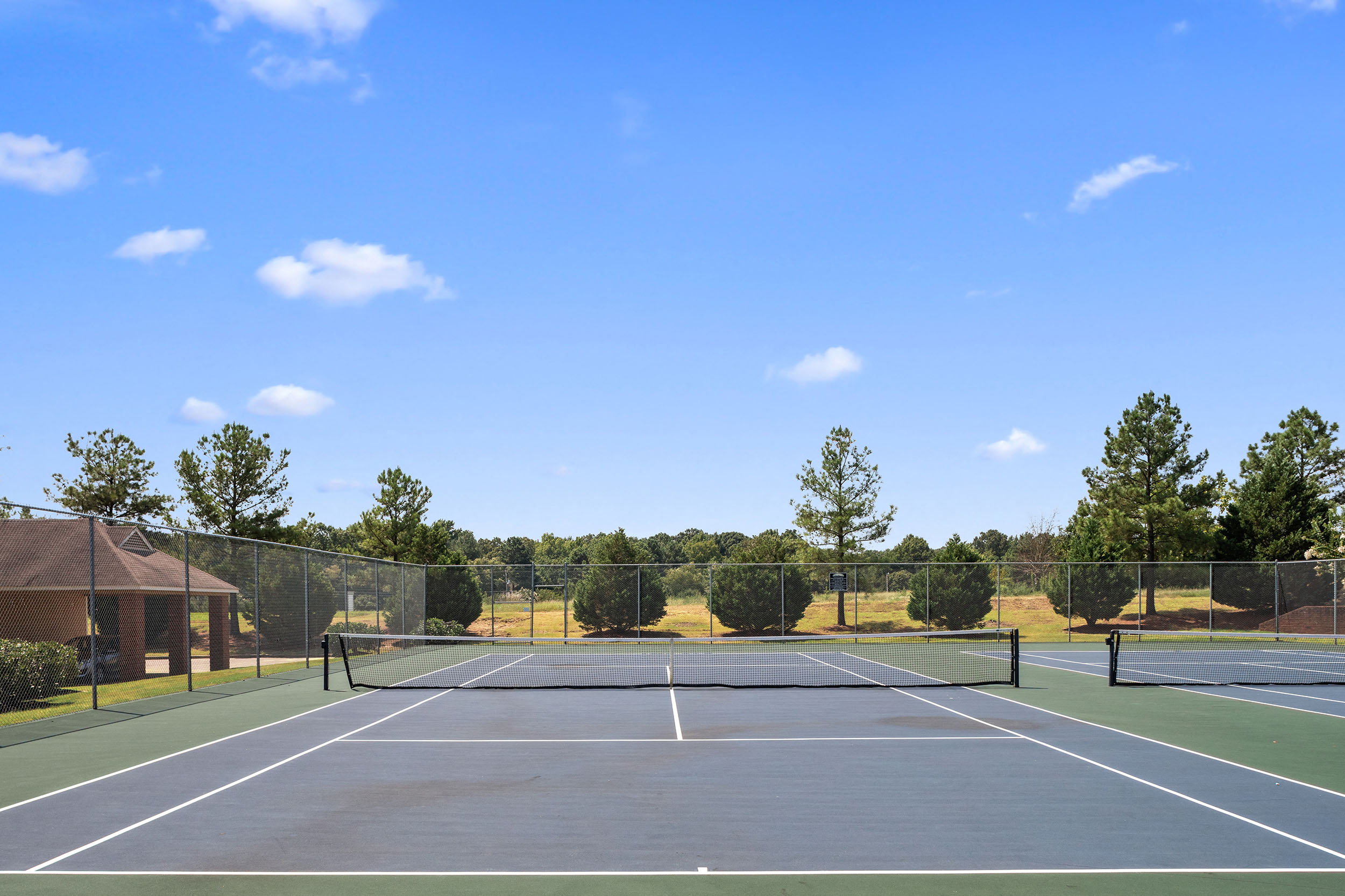 Well-kept outdoor tennis courts at apartments in Cordova, TN
