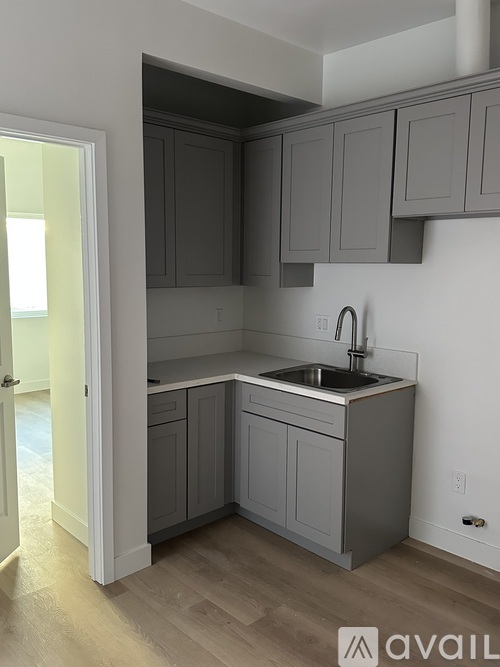A kitchen with a stove top oven and a sink.